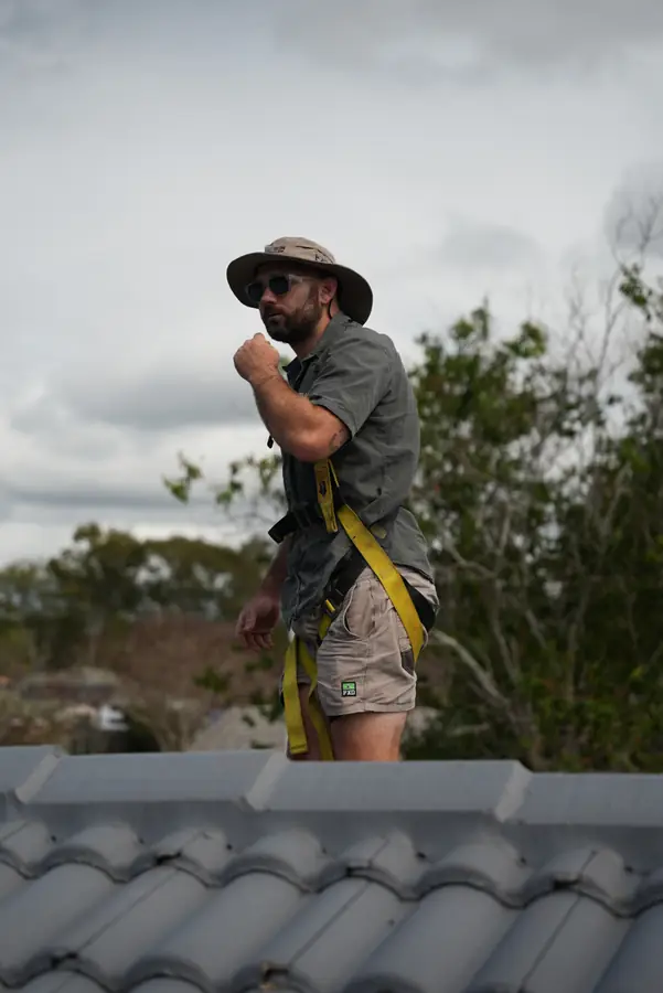 QLD Blue Gum Renewables installer wearing roof safety equipment during an installation